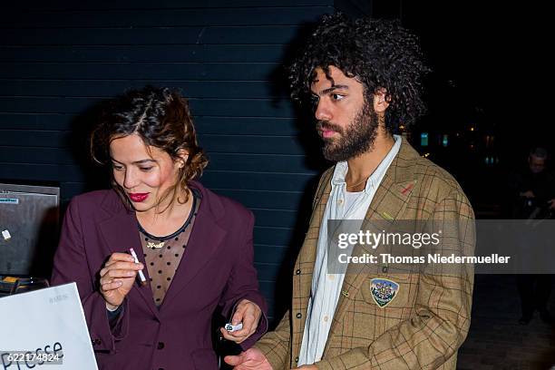 Noah Becker and Taina Moreno de Oliveira Lagoeiro attend the red carpet during the grand opening of Roomers hotel on November 10, 2016 in...