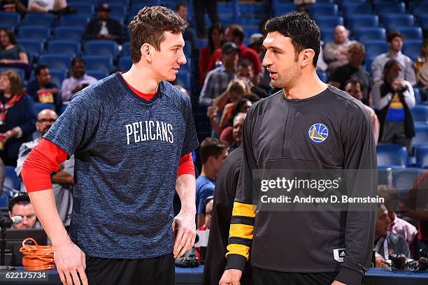 Omer Asik of the New Orleans Pelicans and Zaza Pachulia of the Golden State Warriors talk before a game at Smoothie King Center on October 28, 2016...