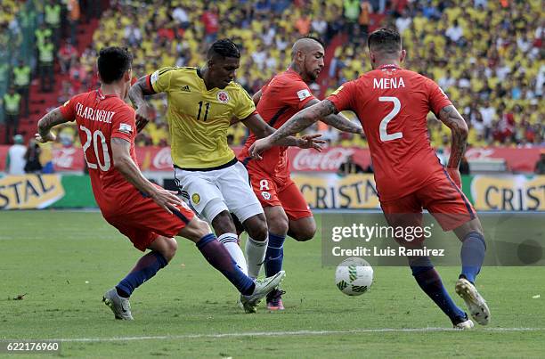 Orlando Berrio of Colombia vies for the ball with Arturo Vidal, Eugenio Mena and Charles Aranguiz of Chile during a match between Colombia and Chile...