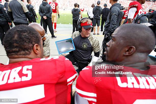 Outside Linebackers Coach Jason Tarver of the San Francisco 49ers talks with Ahmad Brooks and Tank Carradine on the sideline during the game against...