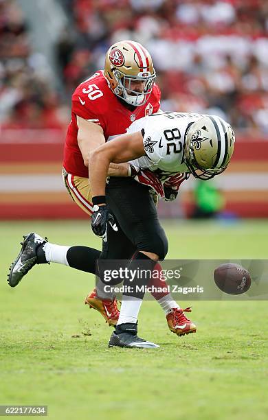 Nick Bellore of the San Francisco 49ers breaks up a pass to Coby Fleener of the New Orleans Saints during the game at Levi Stadium on November 6,...