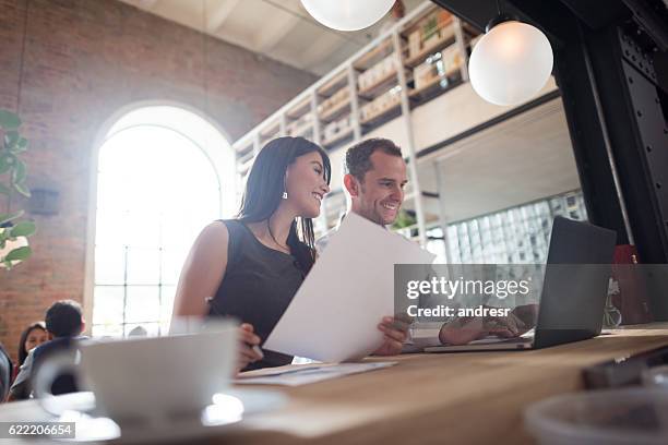 business couple working at a restaurant - two executive man coffee shop stockfoto's en -beelden