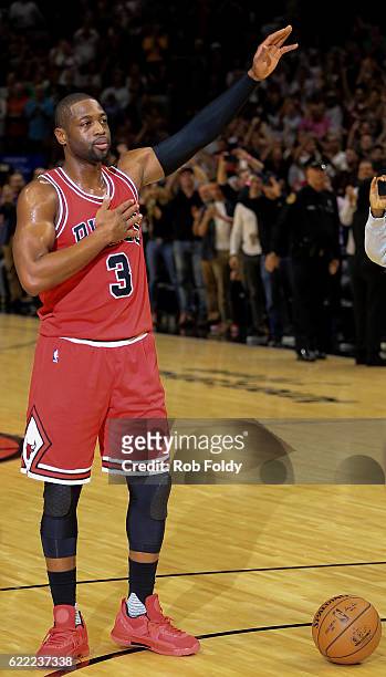 Dwyane Wade of the Chicago Bulls waves to the crowd during the first quarter of the game against the Miami Heat at American Airlines Arena on...