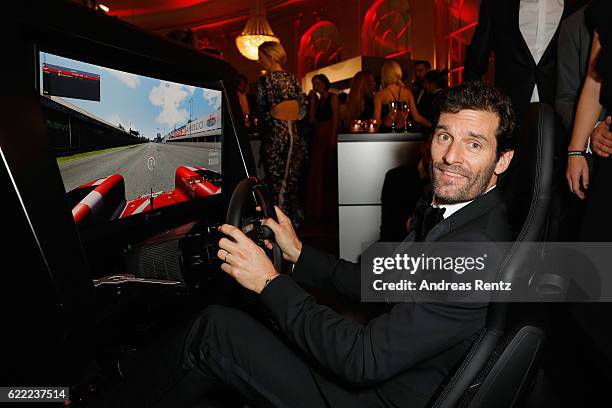 Mark Webber tries a driving simulator at the GQ Men of the year Award 2016 after show party at Komische Oper on November 10, 2016 in Berlin, Germany.