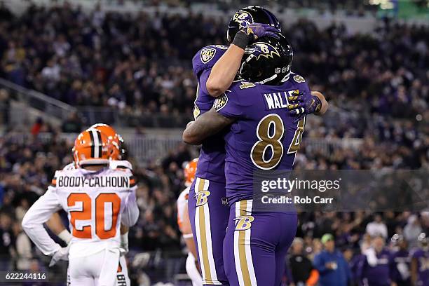 Tight end Darren Waller of the Baltimore Ravens celebrates with teammate fullback Kyle Juszczyk after scoring a third quarter touchdown against the...