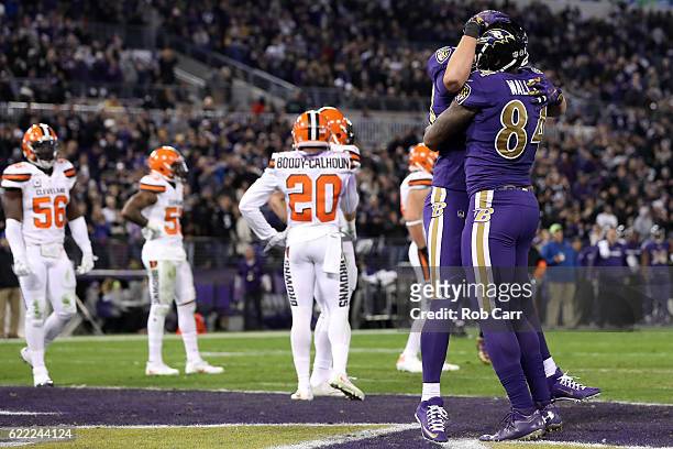 Tight end Darren Waller of the Baltimore Ravens celebrates with teammate fullback Kyle Juszczyk after scoring a third quarter touchdown against the...