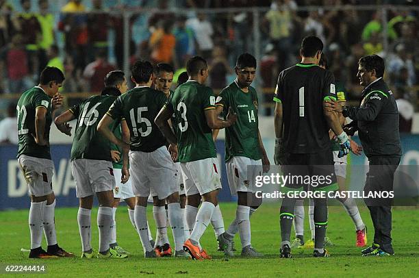 Bolivia's coach Angel Guillermo Hoyos talks to his players after losing their WC 2018 qualifier football match against Venezuela, in Maturin,...