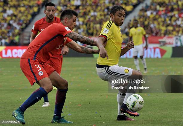 Enzo Roco of Chile fights for the ball with Luis Fernando Muriel of Colombia during a match between Colombia and Chile as part of FIFA 2018 World Cup...