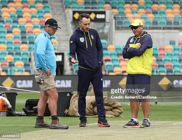 Bellerive Oval curator Marcus Pamplin speaks with Faf du Plessis of South Africa and Russell Domingo, coach of South Africa as they check the pitch...