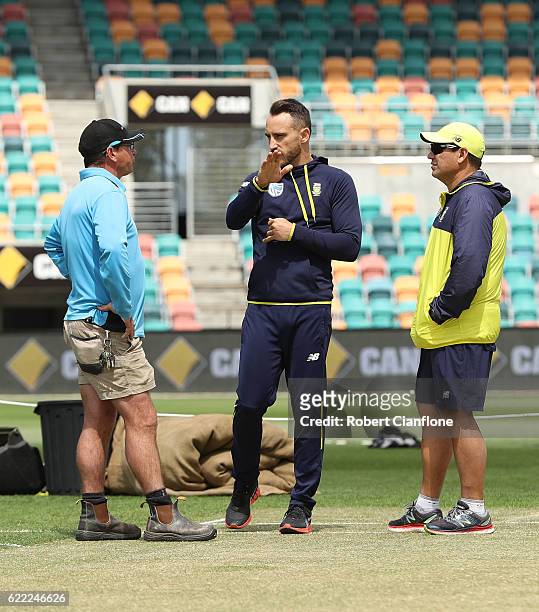 Bellerive Oval curator Marcus Pamplin speaks with Faf du Plessis of South Africa and Russell Domingo, coach of South Africa as they check the pitch...