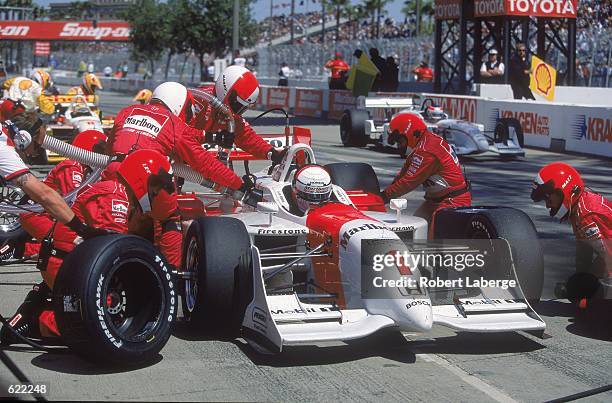 Driver Gil de Ferran of Brazil who drives a Honda Reynard for Marlboro Team Penske makes a pit stop during the Toyota Grand Prix of Long Beach, part...