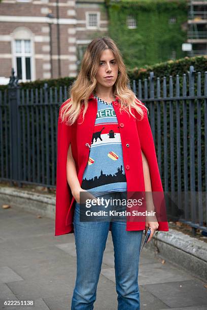 Fashion features editor at L"u2019Express Marta Represa wears a Pinko cape, Marc Jacobs jumper, Notify jeans day 4 of London Womens Fashion Week...