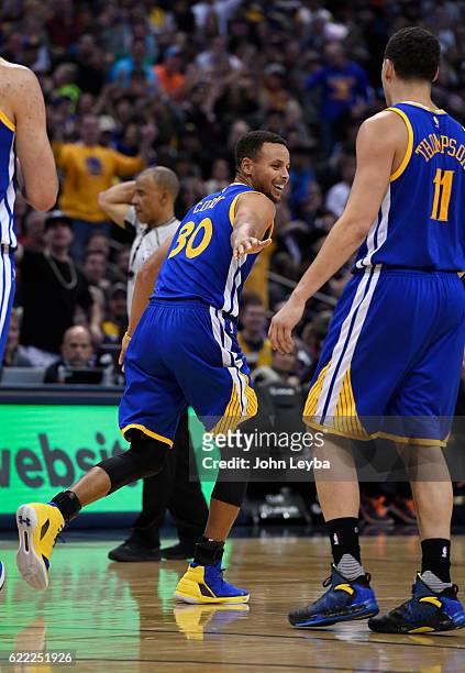 Golden State Warriors guard Stephen Curry smiles after hitting a three pointer and getting fouled on the play during the third quarter against the...