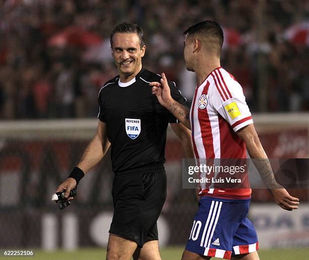 Referee Martin Lousteau talks to Derlis Gonzalez of Paraguay during a match between Paraguay and Peru as part of FIFA 2018 World Cup Qualifiers at...