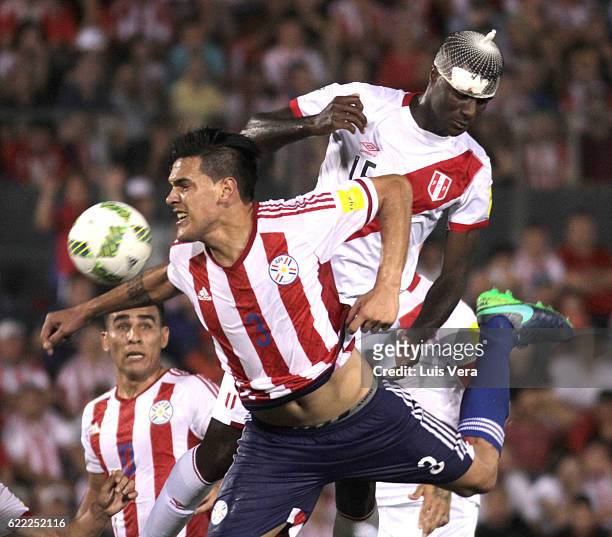 Christian Ramos of Peru jumps for the ball with Gustavo Gomez of Paraguay during a match between Paraguay and Peru as part of FIFA 2018 World Cup...