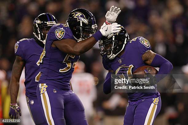 Defensive back Jerraud Powers of the Baltimore Ravens celebrates with teammate inside linebacker Zach Orr after intercepting the ball in the third...