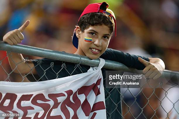 Fan of Venezuela holds a flag during a match between Venezuela and Bolivia as part of FIFA 2018 World Cup Qualifiers at Monumental de Maturin Stadium...
