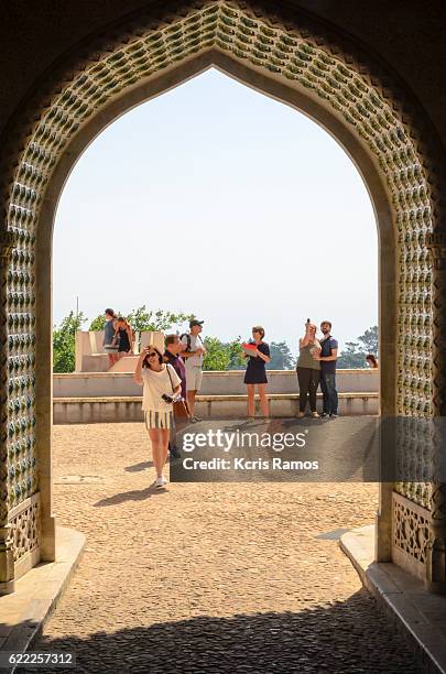 portal in gothic style with tourists entering the castle of sintra portugal - quinta da regaleira photos stock pictures, royalty-free photos & images