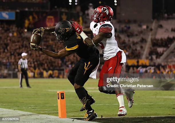 Wide receiver Tim White of the Arizona State Sun Devils catches a 12 yard touchdown reception ahead of defensive back Dominique Hatfield of the Utah...