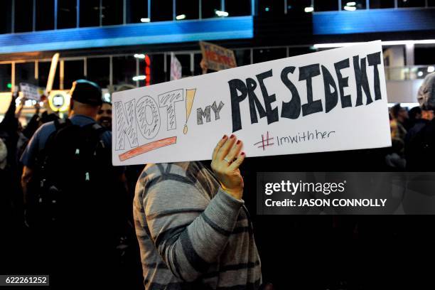 Demonstrator holds up a sign as others protest the election of President elect Donald Trump in Denver, Colorado on November 10, 2016.