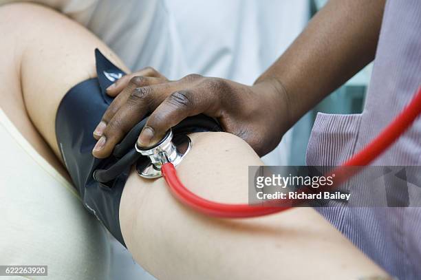checking pulse in hospital - district nurse stock pictures, royalty-free photos & images