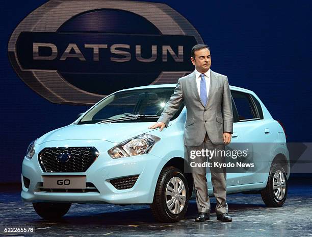 India - Nissan Motor Co. CEO Carlos Ghosn stands by a Datsun brand car premiered in Gurgaon, India, on July 15, 2013. Nissan is reviving the historic...