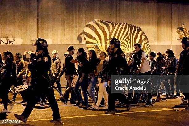 Protesters gather and block the roads of the downtown of Oakland during a protest against President-elect Donald Trump of Republican Party in...