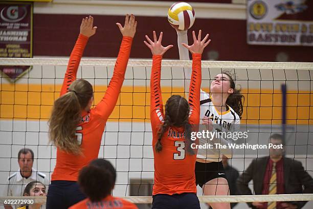 Oakton Cougars Grace Cozad goes for the kill between West Springfield Spartans Hailey Olsen and West Springfield Spartans Sara Khatouri in the third...