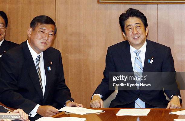 Japan - Prime Minster Shinzo Abe and Shigeru Ishiba, secretary general of the ruling Liberal Democratic Party, attend a meeting of their party...