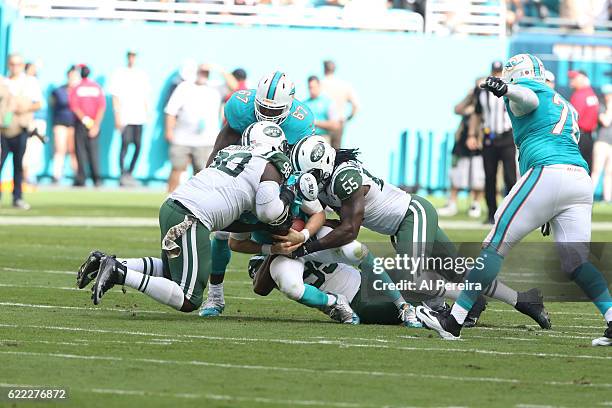 Linebackers Josh Martin and Lorenzo Mauldin of the New York Jets sack Quarterback Ryan Tannehill of the Miami Dolphins on November 6, 2016 at Hard...