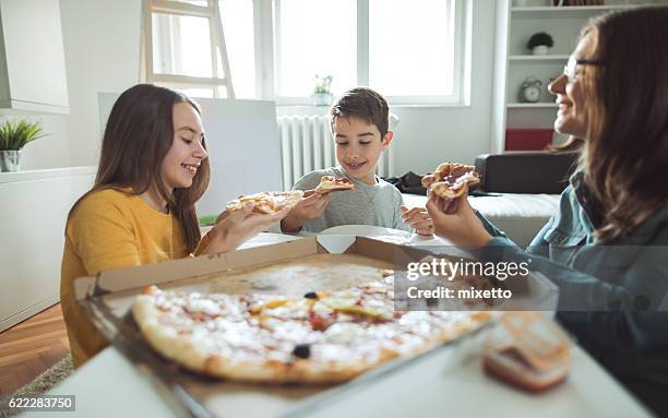 family eating pizza at home - teenagers eating with mum stock pictures, royalty-free photos & images