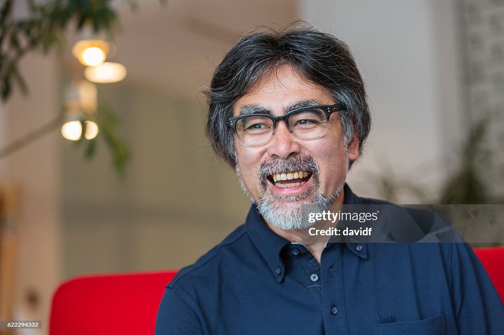 Excited and Happy Senior Japanese Man Relaxing at Home