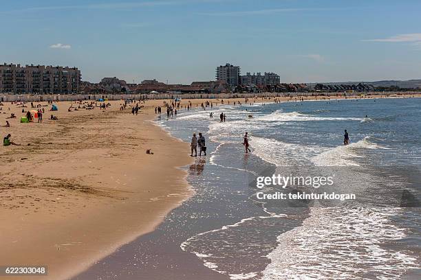 people having fun at sandy beach in calais france - calais stock pictures, royalty-free photos & images