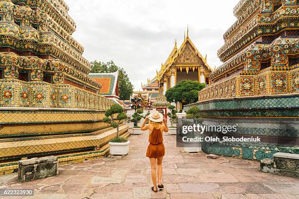 woman walking in wat pho temple - thailand tourist stock pictures, royalty-free photos & images