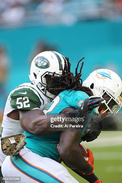 Linebacker David Harris of the New York Jets makes a stop against the Miami Dolphins on November 6, 2016 at Hard Rock Stadium in Miami Gardens,...