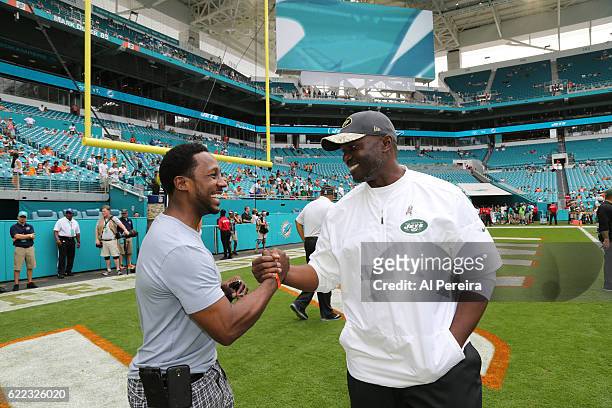 Head Coach Todd Bowles of the New York Jets meets with Desmond Howard before the game against the Miami Dolphins on November 6, 2016 at Hard Rock...