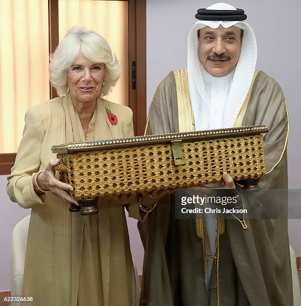 Camilla, Duchess of Cornwall is presented with a box of traditional items manufactured by women from the refuge by Minister of Labour and Social...