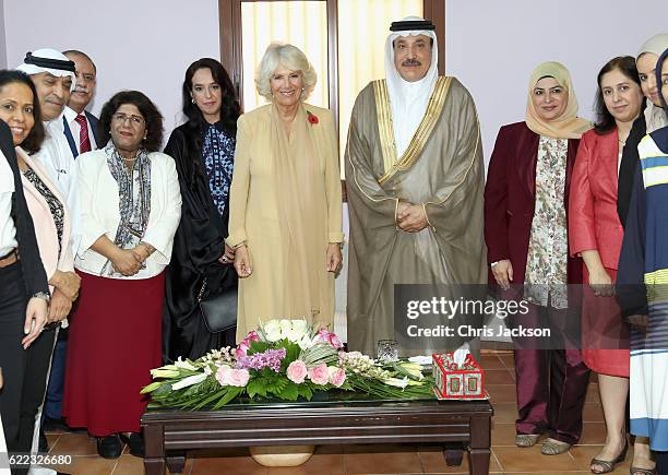 Camilla, Duchess of Cornwall poses for a group picture next to Minister of Labour and Social Development Jameel Bin Mohammed Ali Humaidan and Sheikha...