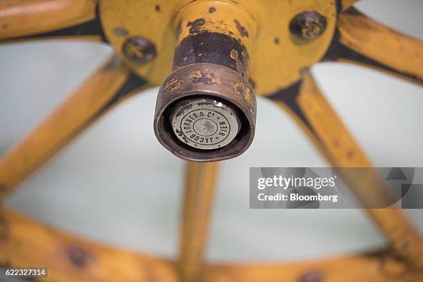 Branded bolt sits on the wheel hub of an Egger-Lohner-Elektromobil electric powered carriage, developed by Ferdinand Porsche in 1898, inside the...