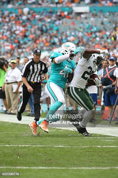 Linebacker Spencer Paysinger of the Miami Dolphins makes a stop against the New York Jets on November 6, 2016 at Hard Rock Stadium in Miami Gardens,...