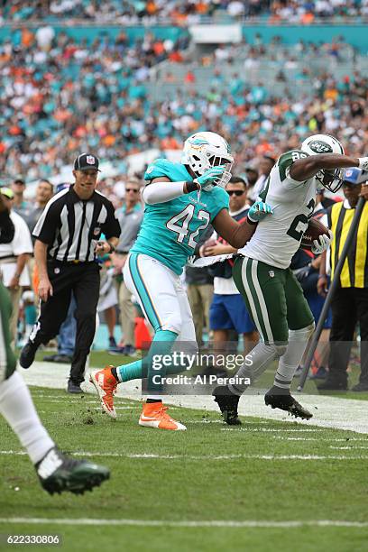 Linebacker Spencer Paysinger of the Miami Dolphins makes a stop against the New York Jets on November 6, 2016 at Hard Rock Stadium in Miami Gardens,...