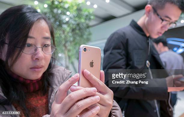 Customer is trying an iPhone 7 in an Apple Store. Because of the competition from the domestic brands like Xiaomi and Huawei, the demand for Apple's...