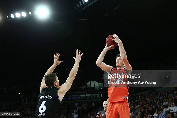 Cameron Gliddon of the Taipans shoots over Kirk Penney of the Breakers during the round six NBL match between the New Zealand Breakers and the Cairns...