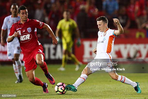 Matthew McKay of Brisbane Roar and Sergio Guardiola of Adelaide United compete for the ball during the round six A-League match between Adelaide...