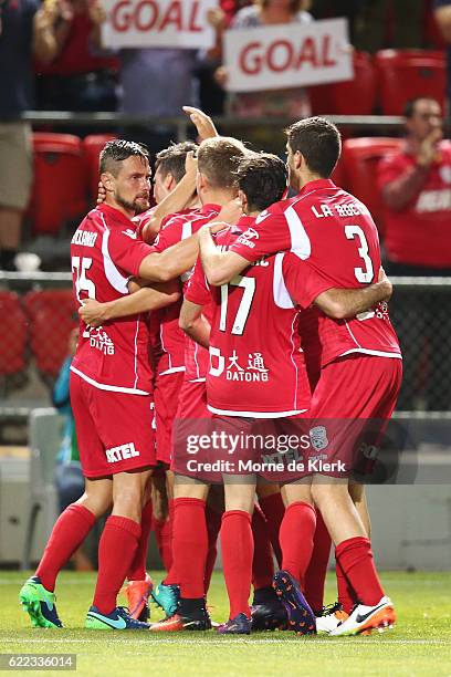 Adelaide players celebrate with Sergio Guardiola after he scored a goal during the round six A-League match between Adelaide United and Brisbane Roar...
