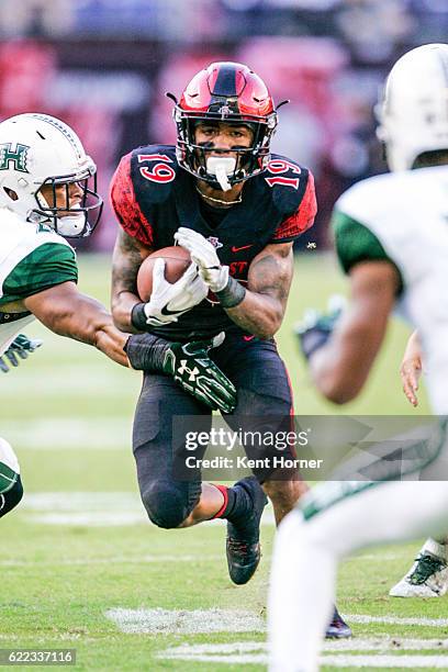 Donnel Pumphrey of the San Diego State Aztecs runs with the ball in the first half against the Hawaii Rainbows in Qualcomm Stadium on November 5,...