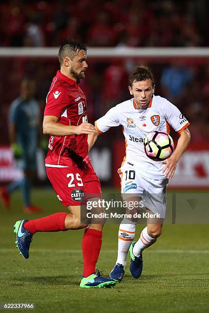 James Holland of Adelaide United competes with Brett Holman of Brisbane Roar during the round six A-League match between Adelaide United and Brisbane...