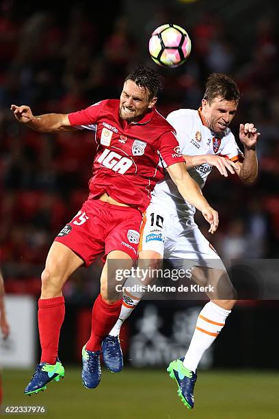 James Holland of Adelaide United competes in the air with Brett Holman of Brisbane Roar during the round six A-League match between Adelaide United...