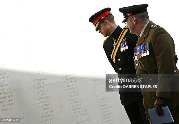 Britain's Prince Harry looks at the names of fallen soldiers inscribed on the Armed Forces Memorial, during a service of remembrance on Armistice Day...
