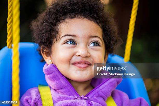 Latin and Black Baby Girl With Blue Eyes Outdoors Smiling 5969
